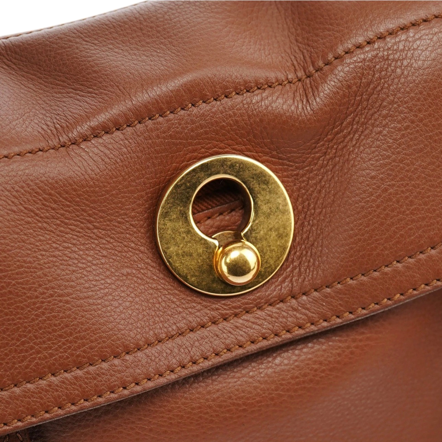 Close-up of Yves Saint Laurent Muse 2-Way Bag with a gold clasp
