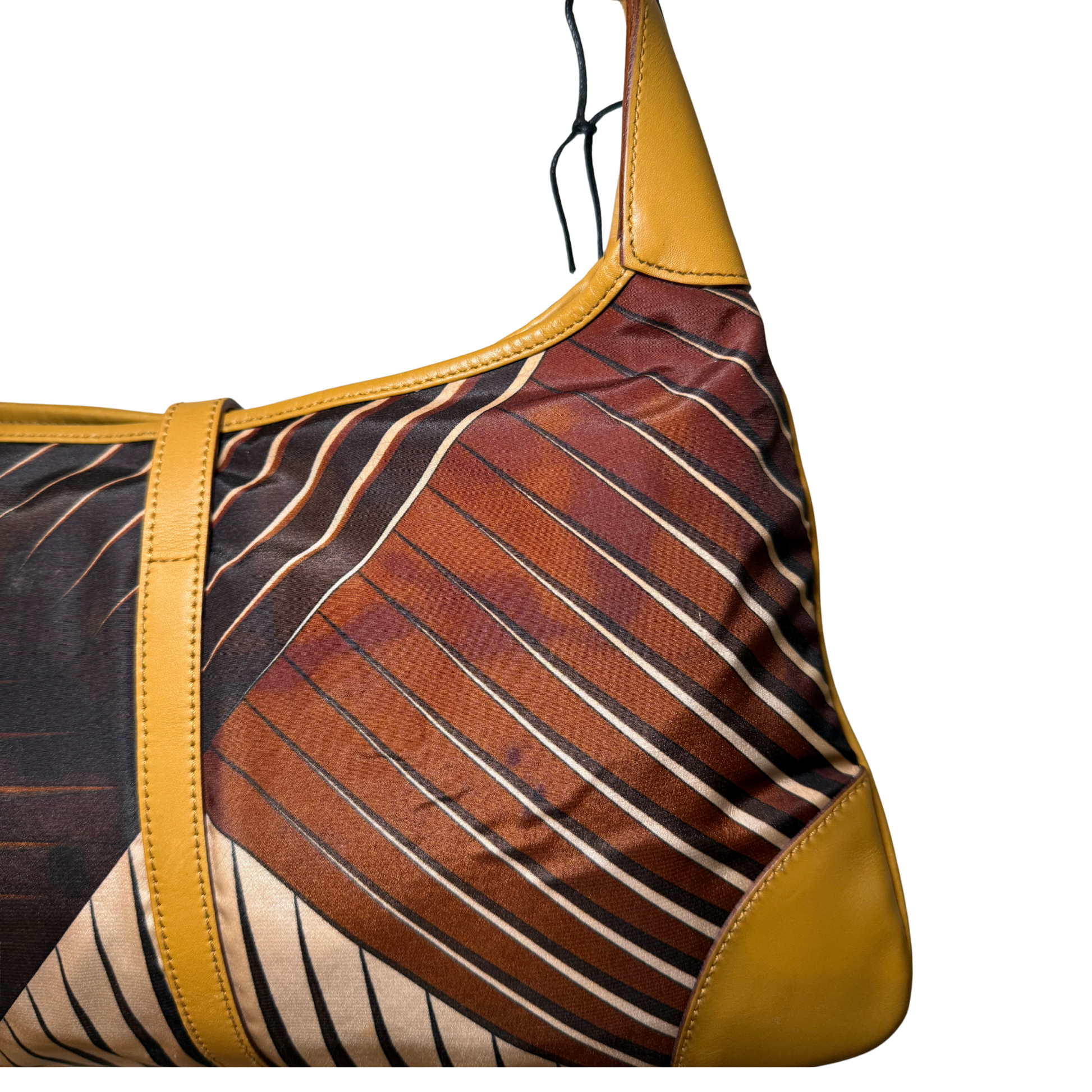 Patterned handbag with brown and yellow design.