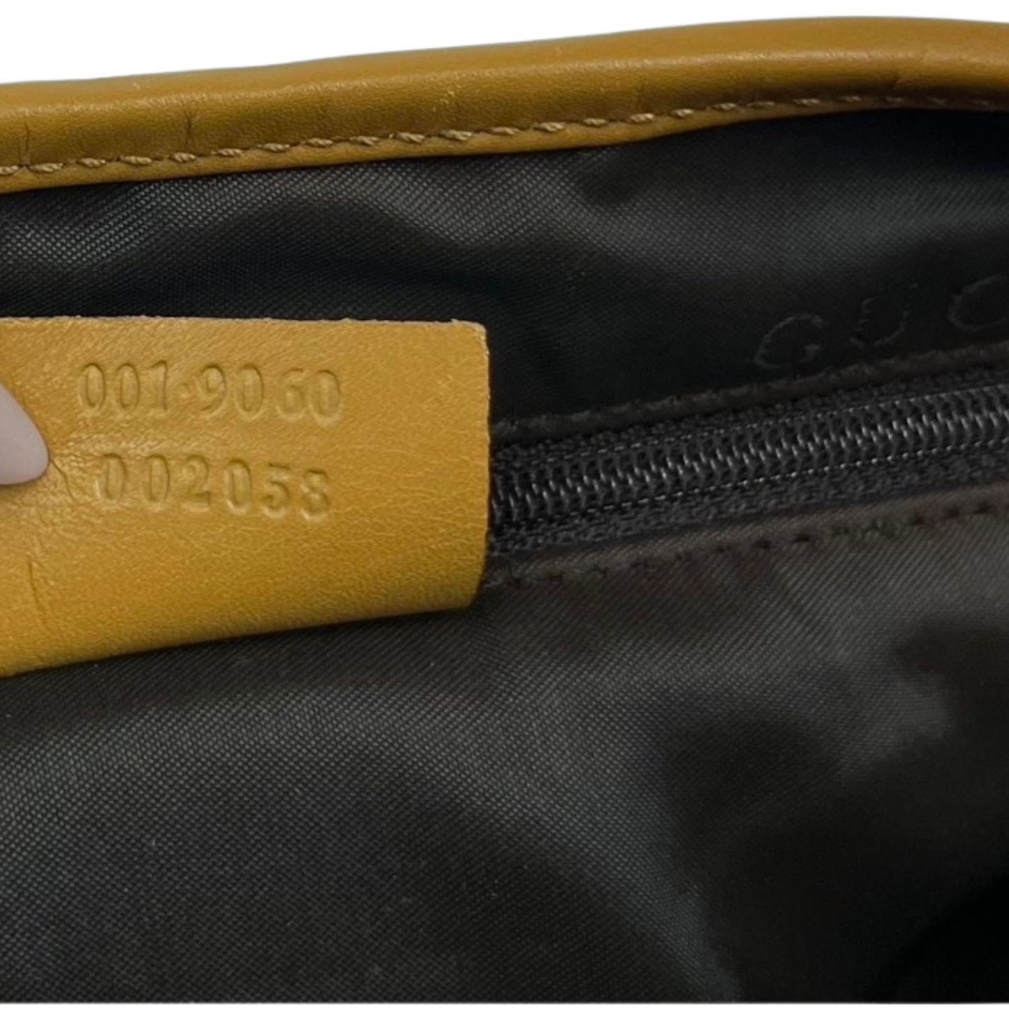 Close-up of a black bag with a yellow label featuring numbers.
