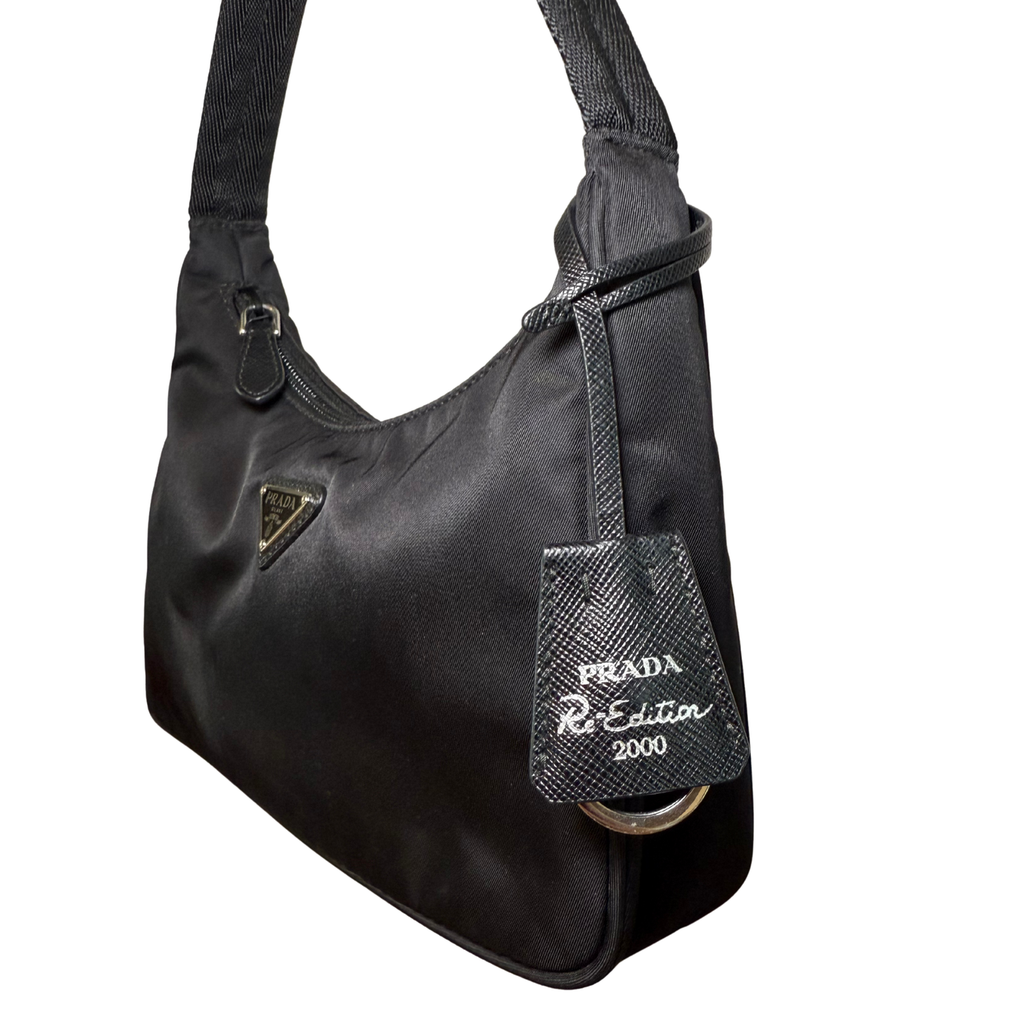 Up close detail view of logo and Prada pre loved bag