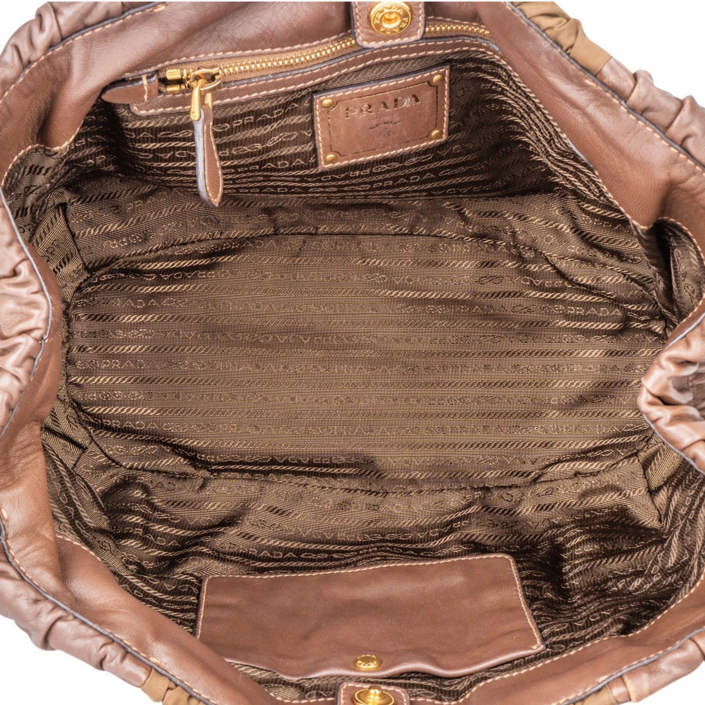 Interior view of Prada handbag brown interior and gold zip pocket
