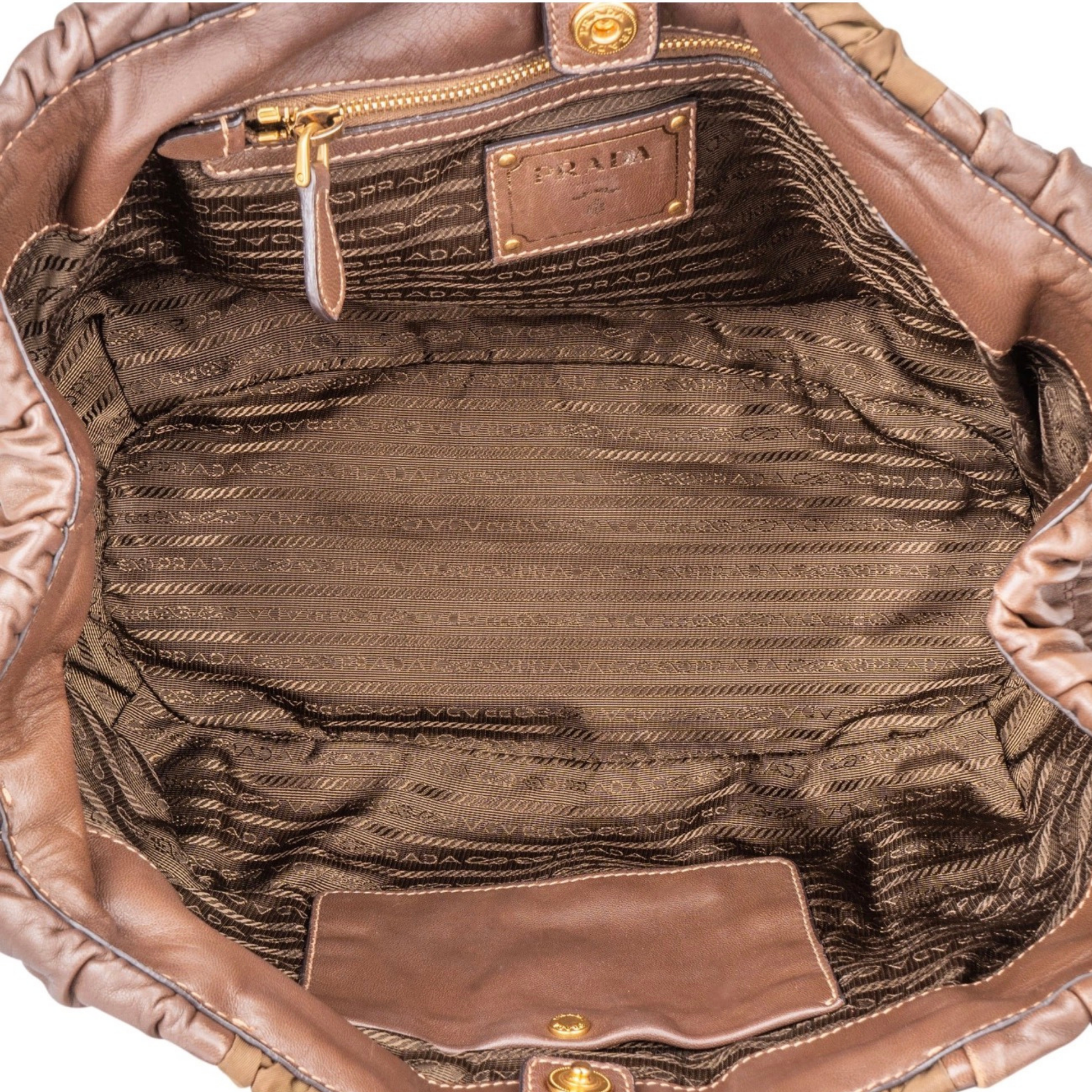 Interior view of Prada handbag brown interior and gold zip pocket