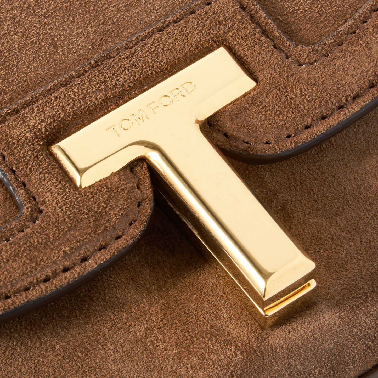 Close-up of gold hardware and Tom Ford logo clasp.
