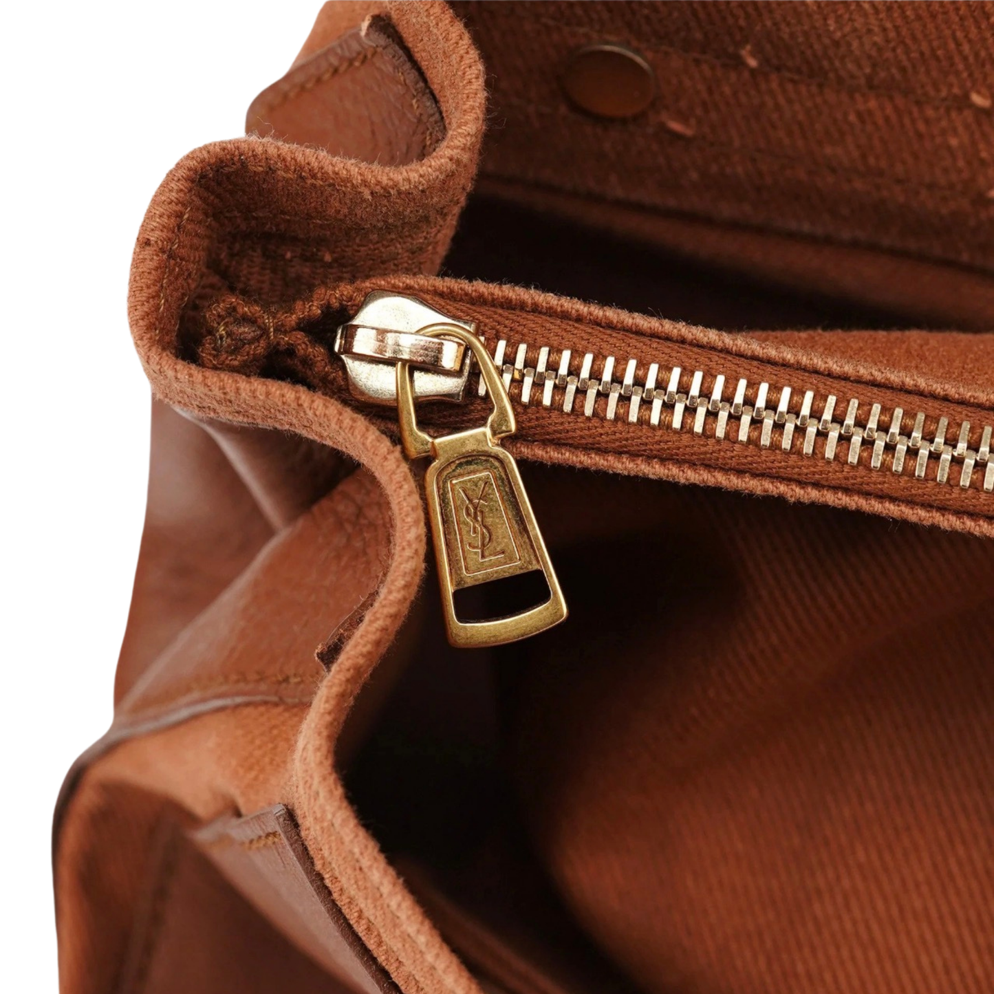 Close-up of a brown YSL Leather bag with a gold zipper pull.