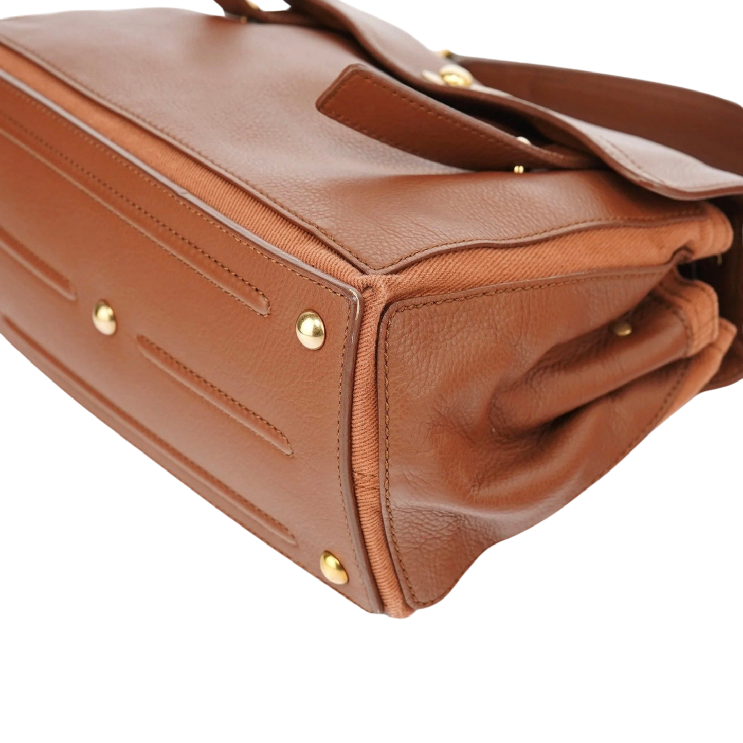 Close-up of a brown leather handbag with gold hardware 